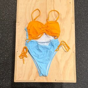 Orange and Blue One Piece Swimsuit with a stomach cut out